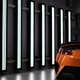 Artsy photo of an Acura NSX Type S, largely silhouetted against vertical light bars